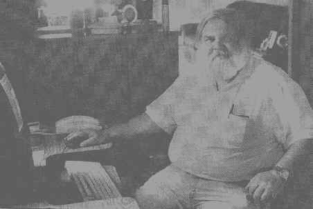 Bob Lemon sitting at his personal computer at home, where he built WegoWeb